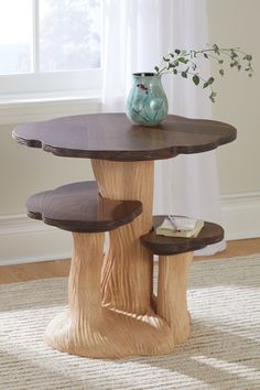 a wooden table with two benches underneath it and a vase sitting on top of the table