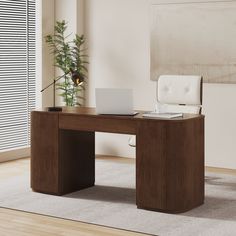 an office desk with a laptop on it in front of a large window and potted plant