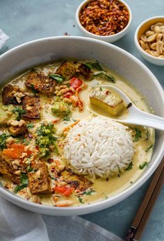 a white bowl filled with rice, meat and veggies