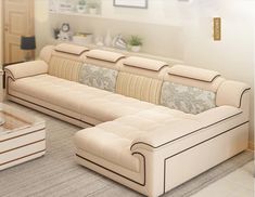 a living room filled with white couches next to a coffee table and vases