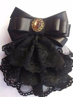 a black lace garter with a golden brooch