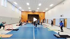 a group of people in a gym doing exercises