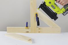 a person using a power drill to attach the dows on a piece of wood