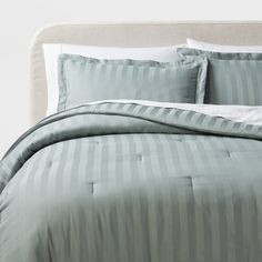 a bed with blue and white striped sheets