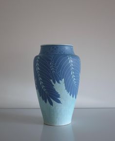 a blue and white vase sitting on top of a table