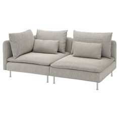 a gray couch with pillows on it and some metal legs in front of white background