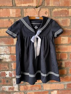 Gorgeous vintage sailor dress. Marked size 98 which translates to age 3-4. Chest: 66cm Waist: free Shoulder to hem: 56cm Nautical Navy Cotton Dress, Navy Cotton Nautical Dress, Navy Nautical Cotton Dress, Navy Short Sleeve School Dress, Vintage Sailor Dress, Vintage Sailor, Sailor Dress, Toddler Dress, Age 3