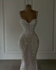 a dress that is on a mannequin in a room with white walls and flooring