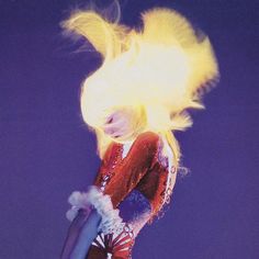 a woman with blonde hair is performing on stage