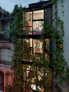 an apartment building with ivy growing on it's windows