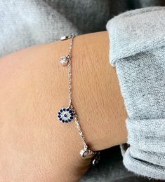 "Beautiful Sterling Silver evil eye bracelet with cross! looks great with other pieces. perfect for everyday wear and as a gift. * bracelet is 7.5 + 1\" extender * evil eye charm is 7 mm  * cubic Zirconia is 3mm -------- Evil Eye The evil eye, known as \"mati\" (μάτι) in Greek culture, is a curse thought to be given by a malicious glare that can cause bad luck or loss. People can knowingly wish negative thoughts on you, but the power of the eye is that some people unknowingly and innocently cast Evil Eye Jewelry Bracelet, Evil Eye Bracelet Silver, Silver Evil Eye Bracelet, Silver Friendship Bracelets, Bracelet With Cross, Greek Culture, Bracelet Diamond, Gift Bracelet, Bracelet Friendship