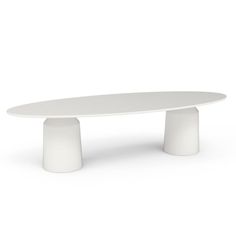 an oval table with two white pedestals on the top and one in the middle