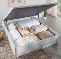 a bed with an open storage compartment underneath it