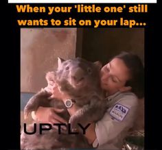 a woman holding a cat in her arms with caption that reads, when your little one still wants to sit on your lap