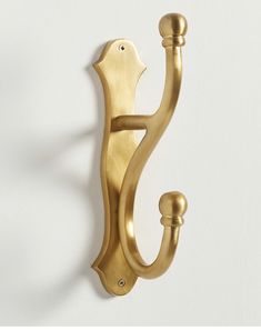 a gold door handle on a white wall