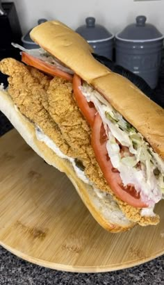 a chicken sandwich is sitting on a cutting board