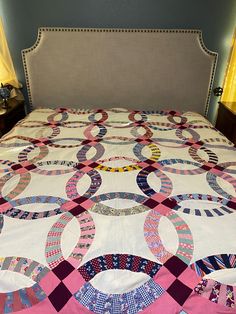 a bed with a quilt on top of it