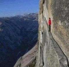 a man climbing up the side of a mountain