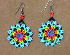 colorful beaded earrings on brown background