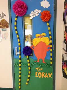 a door decorated with paper flowers and the words the lorax