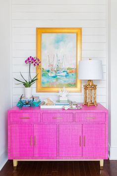 a pink sideboard in front of a painting with boats on it and the words carren credenza pink save $ 350