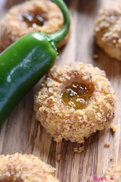 some food on a wooden table with a green pepper in the middle and other foods around it