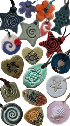 many different colored and shaped ceramic items on a white background, including seashells