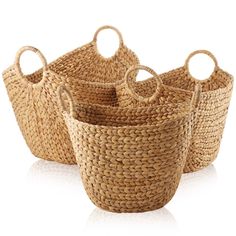 four woven baskets with handles on white background