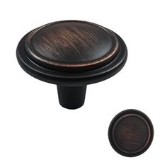 an antique style cabinet knob with a dark wood finish