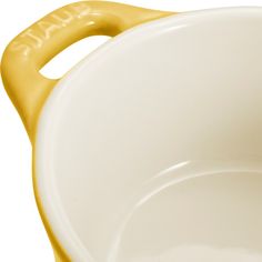 a yellow handle on a white bowl