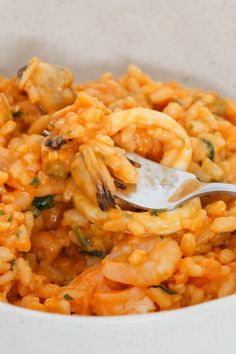 a white bowl filled with pasta and shrimp