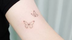 two butterflies tattoo on the arm