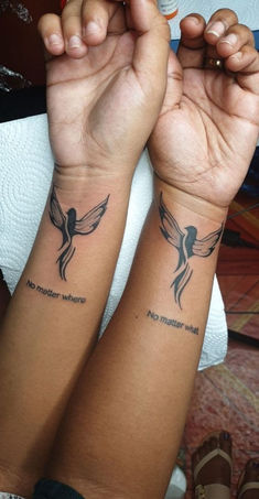 two people with matching tattoos on their arms