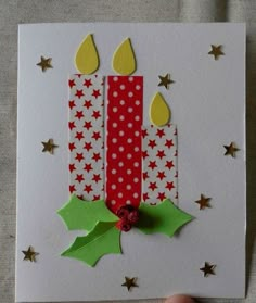 a handmade birthday card with candles and holly