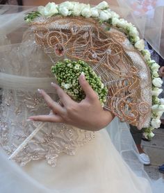 a close up of a person's hand holding an umbrella with flowers on it