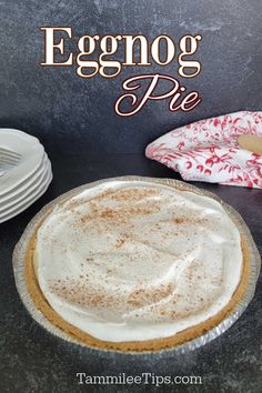 an eggnog pie on a table with plates and napkins in the background