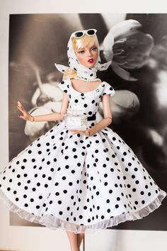 a barbie doll dressed in polka dot dress and goggles, posing for the camera