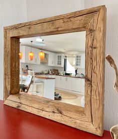 a mirror sitting on top of a red table