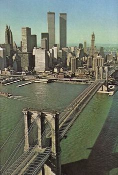 an aerial view of the brooklyn bridge and lower manhattan, new york city in the background