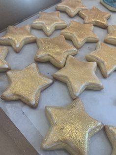 there are many gold stars on the cookie sheet