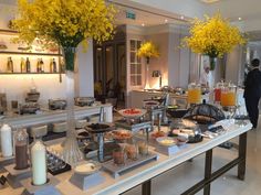 the buffet is full of many different types of food and drinks, including orange juice