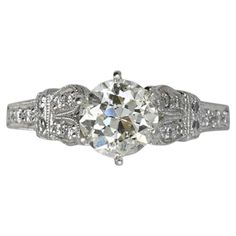 an antique style diamond ring with filigrees