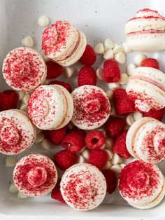 red and white cupcakes with raspberries in the middle, surrounded by marshmallows