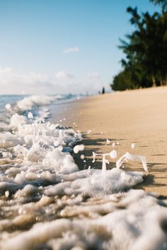 the beach is covered in foam and water