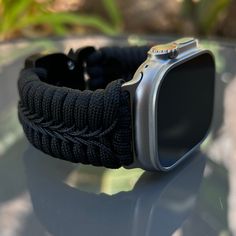 "Handcrafted with 100% Nylon Paracord \"MADE IN USA\".   Our Products include:    ➖Custom handcrafted watch bands \"According to You\". No matter how small or big your wrist size, we will craft your perfect fitting band (wrist size picture measurement required).  ➖Variety of styles to choose from. You may order your band \"As pictured\", or feel free to request changes. If you don't see your favorite style in our page or watch category yet, please contact us and we can discuss your options.  ➖Variety of buckles or clasps (Prices may vary).  ➖FREE FIRST CLASS USPS SHIPPING FOR DOMESTIC U.S. ORDERS (Includes U.S. Military APO/FPO Address Overseas).  Please, refer to policies for handcrafting time frames https://www.etsy.com/shop/Cording2U#policies. These may vary month to month depending on Paracord Apple Watch Band, Apple Watch Bands Men, Adjustable Black Apple Watch Band For Outdoor, Apple Ultra Watch Bands, Adjustable Silver Watch Bands For Outdoor Use, Durable Adjustable Apple Watch Band For Outdoor, Outdoor Apple Watch Band, Black Paracord Bracelet Strap Watch Band, Handmade Black Apple Watch Band For Outdoor