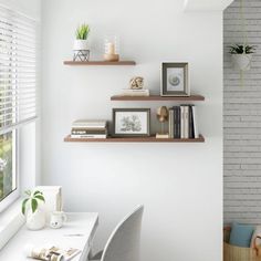 a white room with some shelves on the wall and a desk in front of it