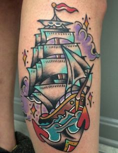 a woman's leg with a ship tattoo on it