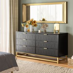 a bedroom with a dresser, mirror and flowers in vases on the sideboard