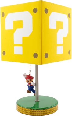 a lamp that has a mario mouse hanging from it's base with a question mark on it