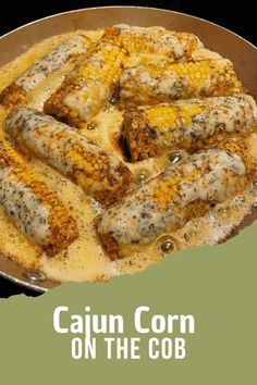 a pan filled with corn on the cob covered in melted cheese and seasoning